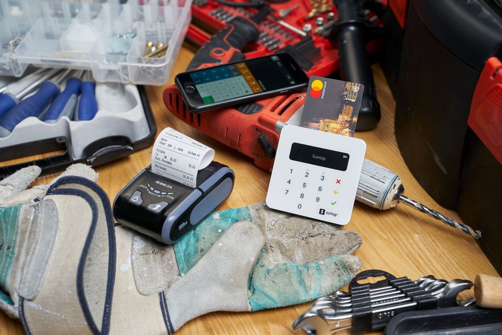 Plastic card in contemporary cash register among tools for maintenance and building